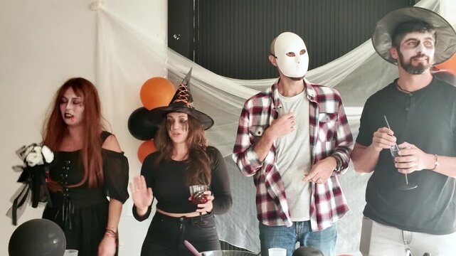 Friends dancing at a Halloween party in costume