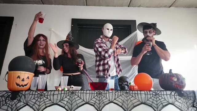 Friends dancing at a Halloween party in costume