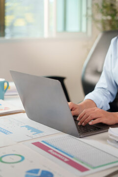 Business professional typing on laptop for artificial intelligence data analysis