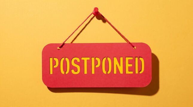 Red sign reading 'POSTPONED' hangs against a vibrant yellow background, indicating a delay or rescheduling of an event