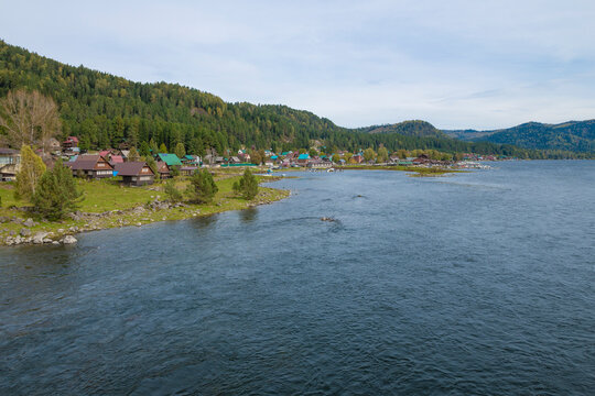 The village of Artybash on the shores of Teletskoye lake on a September afternoon. Altai Republic, Russia