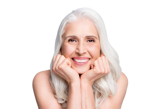 Closeup photo of beautiful aged woman beaming toothy smile touch arms cheekbones isolated grey color background
