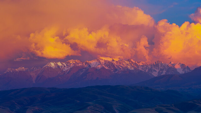 Panoramic Mountain Range Under Dramatic Sunset in Kyrgyzstan