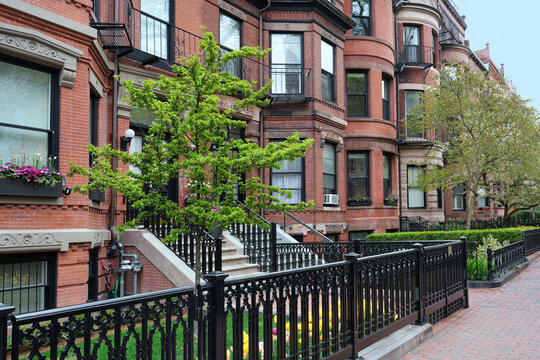 street of old townhouses with bay windows and small front gardens