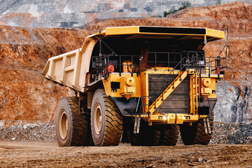 Front view large yellow mining dump truck at quarry edge for industrial banner and heavy equipment background © Parilov