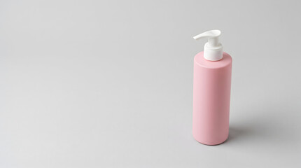 Pink dispenser bottle for cosmetic product mockup standing upright on surface © ChaohM