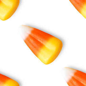 Repeating seamless pattern of candy corn pieces on transparent background