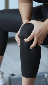 Women while exercising touching painful twisted or broken. Athlete training, running up and down stairs accident. Sport sprained sprain cause injury knee. and pain with leg bones.