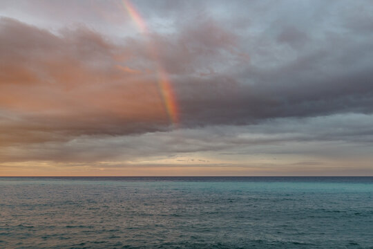 Rainbow over a vast Ligurian sea, under a cloudy sky, Mediterranean, Imperia, Italy