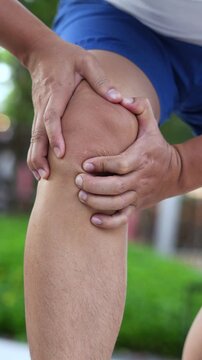Runner touching painful twisted or broken. Athlete training, running up and down stairs accident. Sport sprained sprain cause injury knee. and pain with leg bones.	