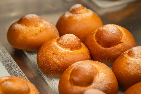 Sweet brioche siciliana dusted with sugar on a small glass plate in Noto, Italy.