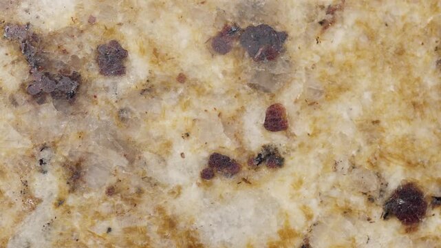 The texture and surface details of the natural granite slowly pan into view. 