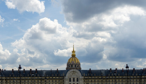 Les Invalides building in Paris under cloudy sky