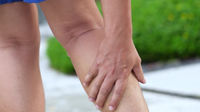 men while exercising touching painful twisted or broken. Athlete training, running up and down stairs accident. Sport sprained sprain cause injury knee. and pain with leg bones.	