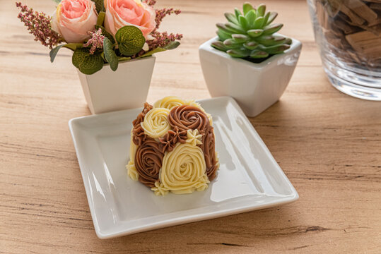 Flower cake on plate with potted flowers