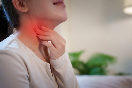 Woman touching sore throat for neck pain and inflammation concept