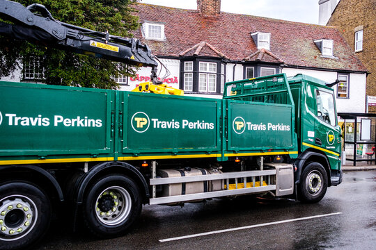 Close Up Cropped Shot Of A Travis Perkins Builders Merchant Lorry With A HIAB Crane Driving On A Town Centre High Street