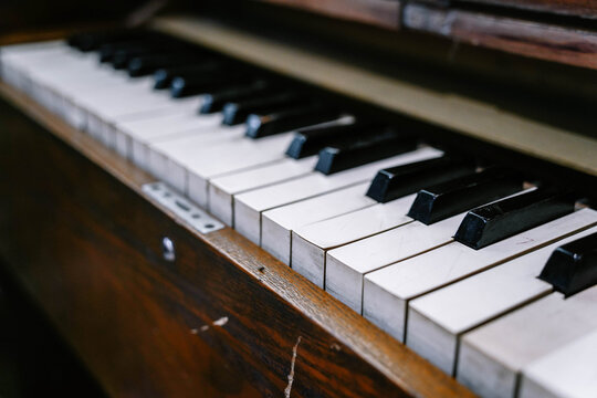 Close-up of an old piano showcasing the aged ivory and ebony keys.