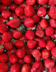 Full frame top view close up shot of fresh ripe red strawberries packed closely together. © Baa
