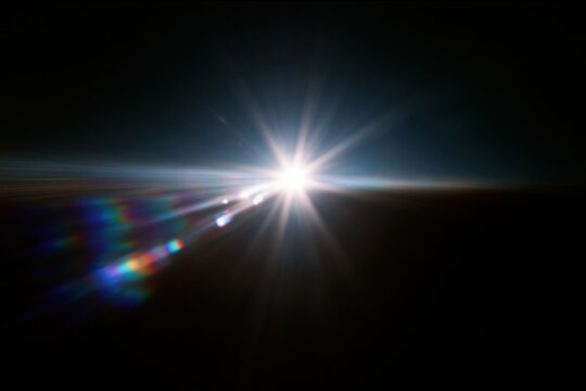 The Sunburst Over the Dark Horizon with Dramatic Lens Flare and Light