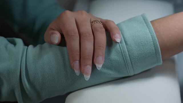 Close up of extended nail shape before polygel application and final stage of nail extension procedure in beauty salon