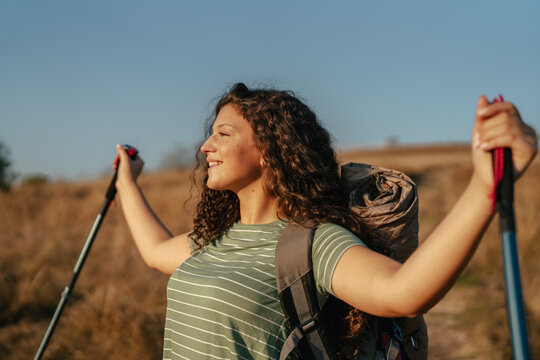 Woman hiking in nature feeling freedom and happiness