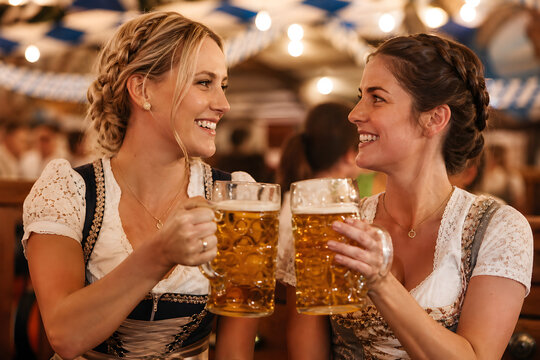 Women toasting with beer steins at a beer hall