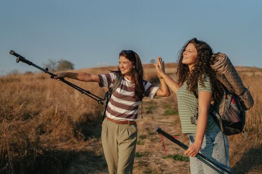 Friends high fiving celebrating hiking success outdoors