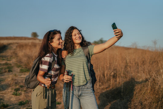 Two women taking a selfie while hiking outdoors