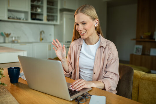 Smiling woman on video call in home kitchen