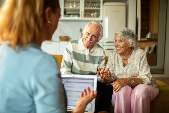 Senior couple meeting advisor at home kitchen