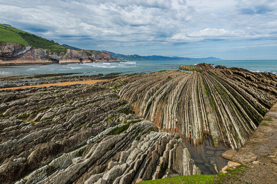 Markante Felsklippen als geologische Formation aus Steinschichten, Flysch am Itzurun-Strand in Zumaia, Spanien