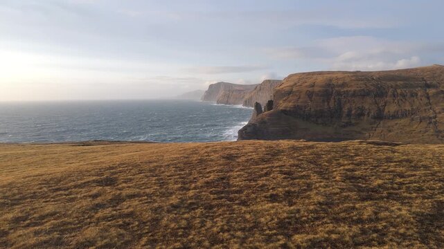 フェロー諸島の断崖と大西洋を空撮、黄金色の草原と海食崖（Faroe Islands Sea Cliffs Aerial 4K）