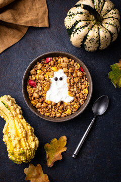 Halloween spooky breakfast with granola and yogurt in shape of ghost