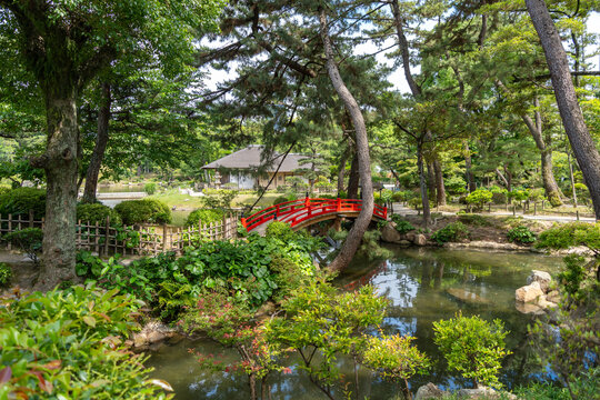 Red bridge in Shukkei-en Japanese garden in Hiroshima, Japan