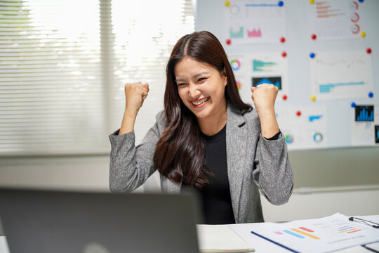 Successful Businesswoman Celebrating a Surprise Achievement in Office