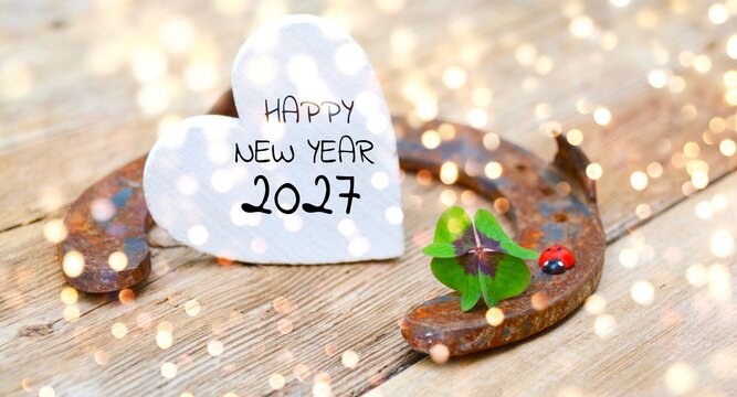 New Year background banner with copy space - Horseshoe with lucky clover - Lucky clover leaves with magical bokeh lights - clover, shamrock, good luck 2027