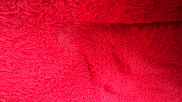 Close-up of bright red plush and fluffy fabric texture