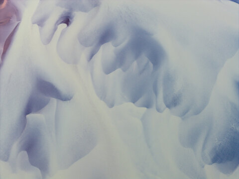 Aerial view of abstract patterns of snow-covered dunes and soft flowing textures on the landscape in Selfoss, Sveitarfelagid Arborg, Iceland.