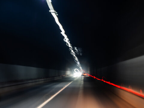 blurred light from headlights and lamps in tunnel