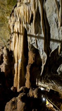 Stalagmite and flowstone inside a limestone cave