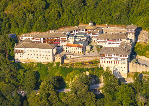 Aerial view of Bigorski Monastery St John the Baptist with historic stone buildings and tiled roofs nestled in the lush green mountains of Radostusha, Komuna e Mavroves dhe, North Macedonia.