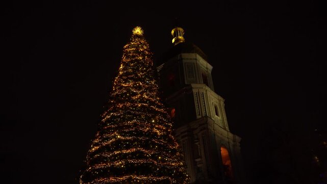 Kyiv Ukraine The main Christmas tree of the country near St. Sophia Cathedral, 11th century. Christmas lights at night. Bell tower square December Winter evening
