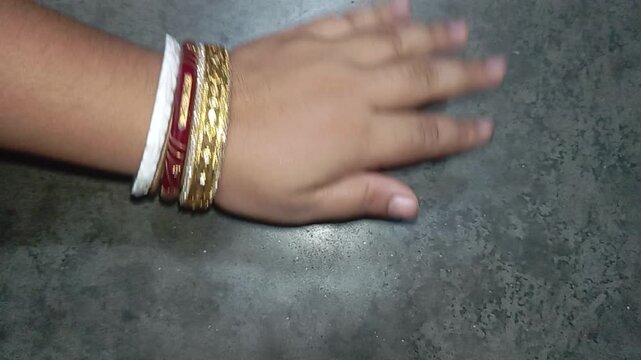 Woman hand with traditional bangles making hand movements close up