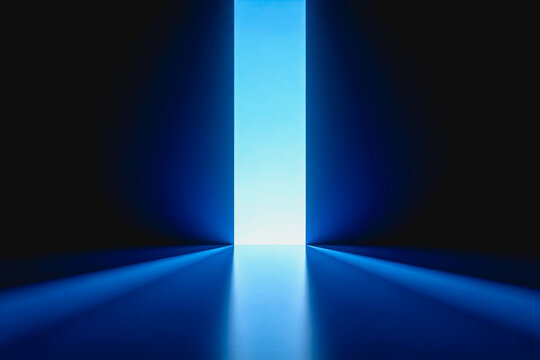 A sleek, minimalist indoor space with a dark blue backdrop and a bright vertical light source at the far end, casting soft light onto the smooth floor.