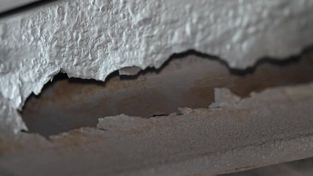 Close up shot of a big rust hole in car body panel.