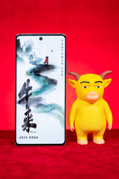 ZhongShan GuangDong China-August 27 2026: Smartphone showing Niu Lai movie poster beside Niu Lai toy model.