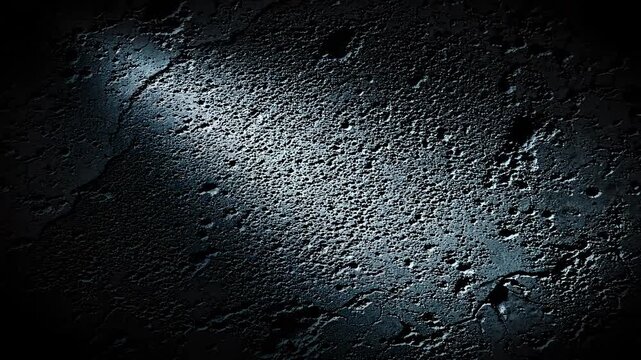 Spotlight moving across dark rough concrete wall texture