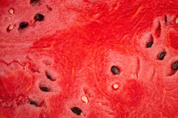 Naklejka premium Slices of juicy watermelon reveal vibrant red flesh and scattered black seeds perfect for summer enjoyment