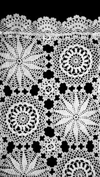 Crochet lace patterns border, crocheted Grandma's Doily, detail of hand-crocheted embroidery, tablecloth, napkin isolated on black background border art design. Craft, vintage linen. Vertical, flatlay